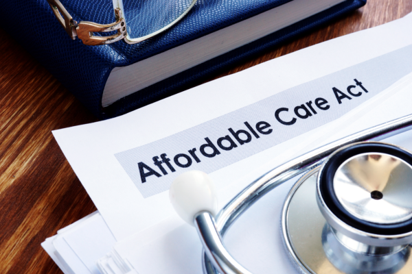A piece of paper with "affordable care about" on it with a stethoscope