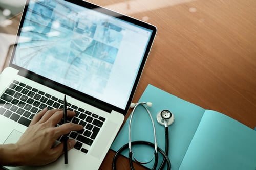 top view of Medicine doctor hand working with modern computer and smart phone on wooden desk as medical concept-Feb-13-2024-06-23-54-2029-PM